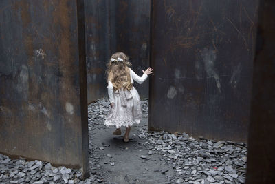 Full length of woman standing against door