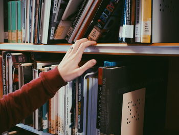 Cropped image of hand on book