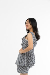 Woman standing against white background