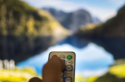 Close-up of hand holding remote control