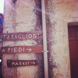 Low angle view of information sign on brick wall