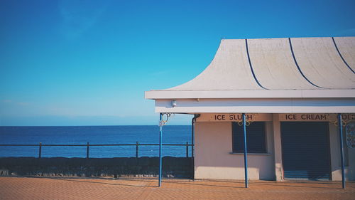 Built structure on beach against clear blue sky