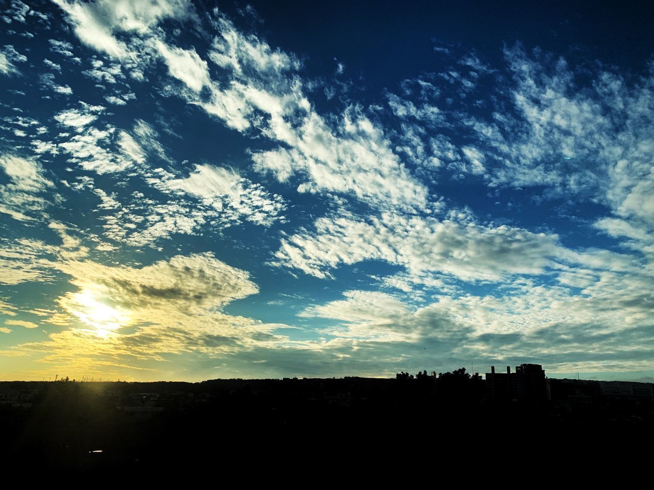 SILHOUETTE LANDSCAPE AGAINST DRAMATIC SKY