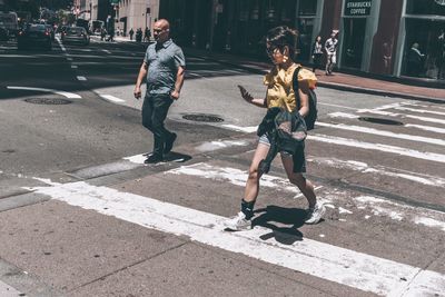 Full length of people walking on road