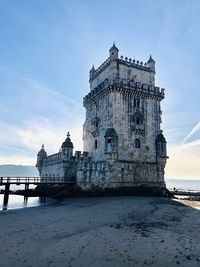 Belem tower in lisboa with view of sea against sky during sunset