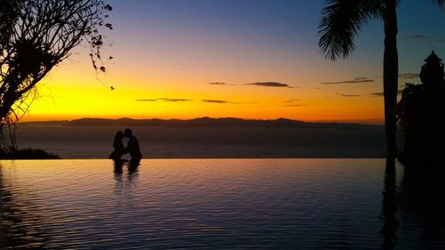 Silhouette of people at sunset