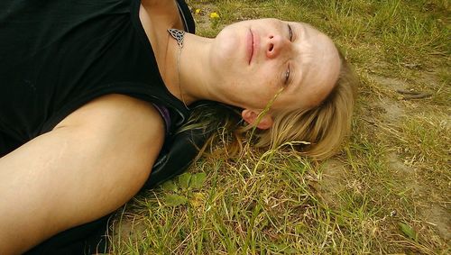 Midsection of woman lying on field
