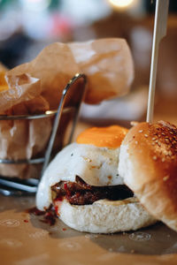 Close-up of fried egg in burger on table