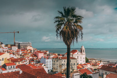 View of town by sea against sky