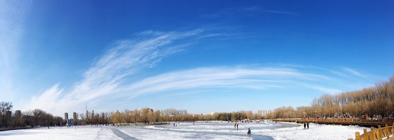 Scenic view of snow covered field against blue sky