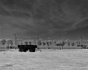 Cars on field against sky