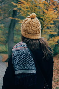 Rear view of woman wearing warm clothing at park during autumn