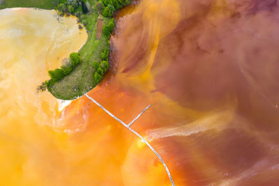 Aerial view of chemical mining waste residuals flooding into a settling basin. 