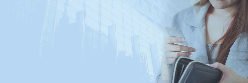 Low angle view of woman standing against wall