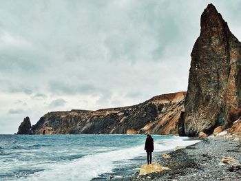 Rear view of woman standing on beach