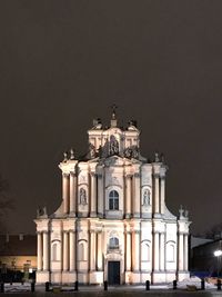 Low angle view of illuminated building against sky at night