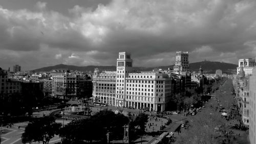 Buildings against cloudy sky