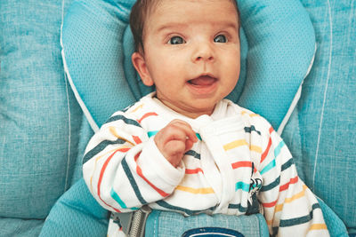 Cute baby girl on bed at home