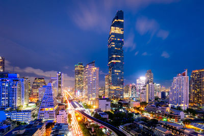 Illuminated buildings in city against sky at night