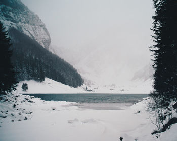 Scenic view of lake against sky during winter