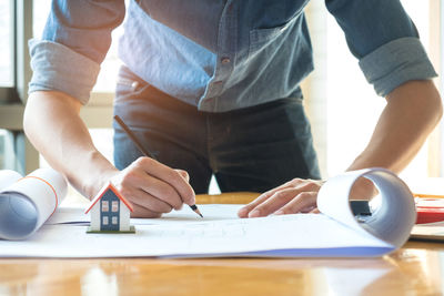 Low section of man working on table