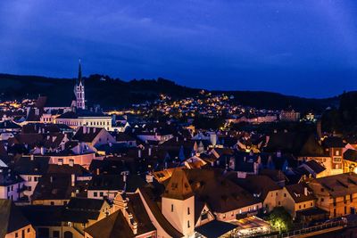 Illuminated cityscape against sky at night