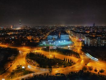 High angle view of illuminated city buildings at night
