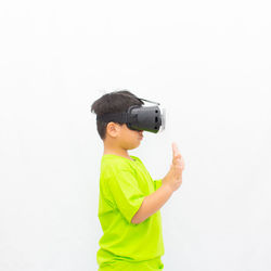 Full length of boy standing against white background