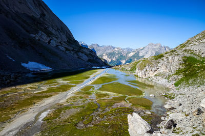 Scenic view of mountains against clear blue sky