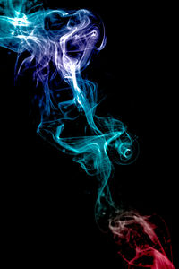 Close-up of illuminated lighting equipment against black background