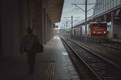 Rear view of woman on railroad station platform