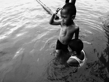 High angle view of shirtless boy in swimming pool