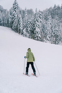 Full length of man skiing on snow covered landscape