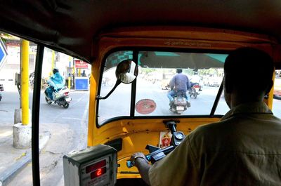 Rear view of people traveling in train