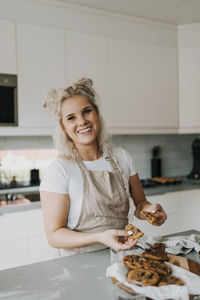 Woman in kitchen preparing cookies