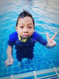 High angle view of boy swimming in pool