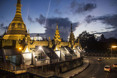 Panoramic view of illuminated buildings against sky at dusk