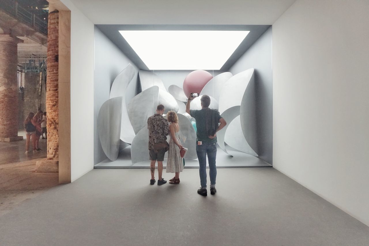 REAR VIEW OF PEOPLE STANDING IN MUSEUM