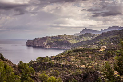 Scenic view of sea and mountains against sky