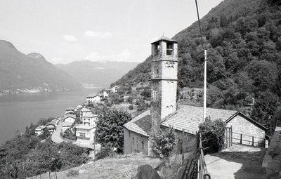 House by buildings against sky
