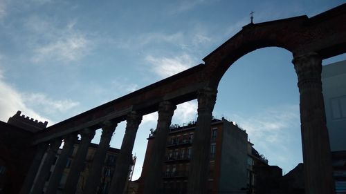 Low angle view of historical building against cloudy sky