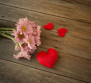 Close-up of pink heart shaped flower on table