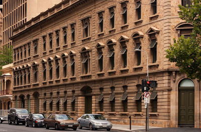 Cars on street against buildings in city