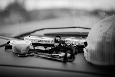 Close-up of various objects on dashboard of car