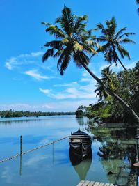 Lone boat in calm lake against blue sky