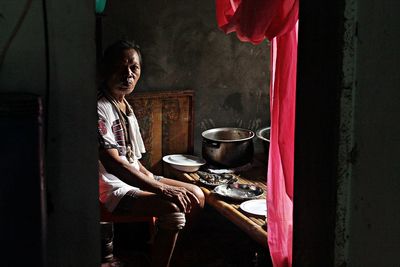 Woman sitting on table at home