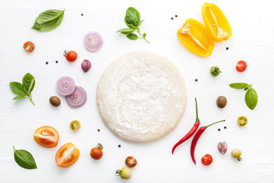High angle view of dough and ingredients on table