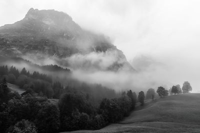 Foggy scenic morning view of mättenberg mountain against the sky  in grindelwald, switzerland