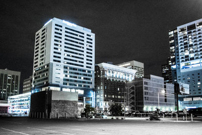 Modern cityscape against sky at night