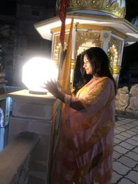 Woman with illuminated lighting equipment